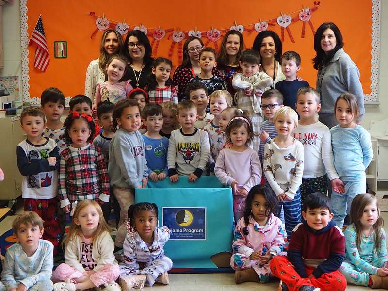 Humpty Dumpty students and teachers in pajamas celebrating the annual Pajama Program collection